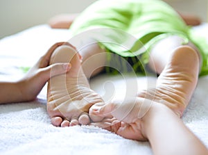 Female foot reflexology in spa