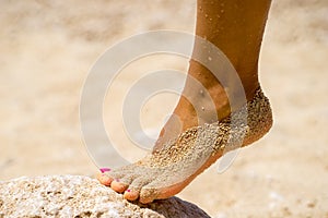 Female foot on sand