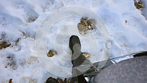 Female foot stepping into the fresh snow of Central Park.