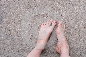 Female Foot Top View. Pink Nail Polish Manicure. Selfie of Woman Bare Feet On Road Background