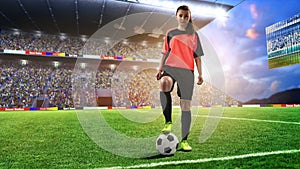 Female football player in red uniform on soccer field photo