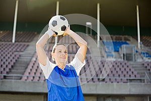 Female football player about to throw a football