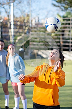 Female football players enjoying training outdoors