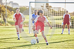 Female football, sports and girls team playing match on field while kicking, tackling and running with a ball. Energy