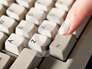 Female forefinger pushes LEFT ALT button. Close-up