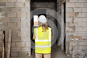 Female foreman officer inspector, building Inspector, engineer or inspector at construction site checking and inspecting