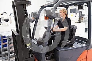 Female Fork Lift Truck Driver Working In Factory