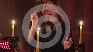 Female fortune teller lights magic incense for paranormal ritual