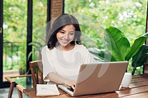 Female freelancer working in coffee shop. Student learning online.