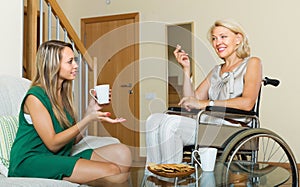 Female friend visiting disabled woman