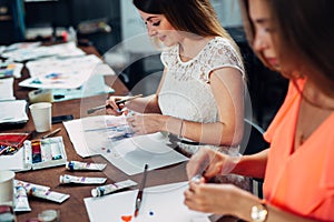 Female friends attending painting workshop together