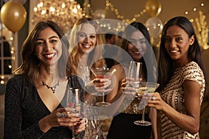 Female Friends Celebrating At Party Make Toast To Camera