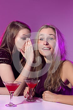 Female friends enjoying cocktails in a nightclub