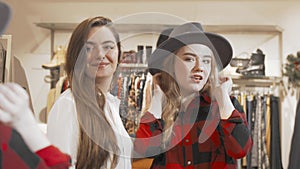 Female friends enjoying shopping at fashion store together