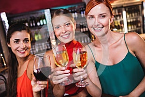 Female friends enjoying wine in night club