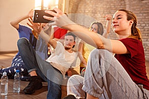 Female with friends making selfie indoor