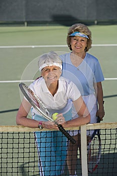 Female Friends Playing Doubles At The Tennis Court