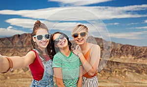 Female friends taking selfie over grand canyon