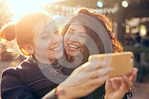 Female friends two women taking selfie during weekend getaway Outdoors