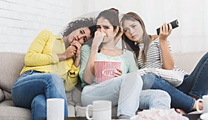 Female friends watching melodrama film at home