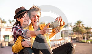 Female friendship concept with girls couple taking selfie outdoors in Tenerife - Lgbtq genuine love relationship
