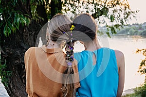 Female friendship femininity, diverse, support, partnership, girlfriend concept. Two girls blonde, brunette, with braided plait
