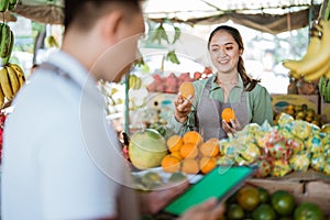 female fruit seller checking the sunkist photo