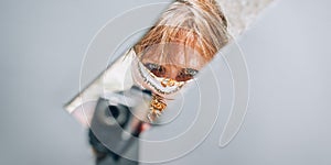 Female gangster bandit with headscarf over her face holding gun