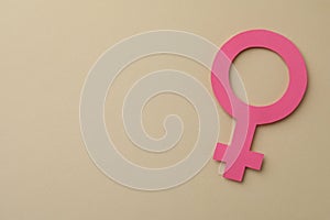 Female gender sign and space for text on beige background, top view. Women`s health concept