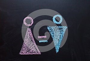 The female gender symbol is equal to the male concept of gender equality. Drawing with chalk on the chalk Board