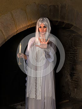 Female ghost with burning candle