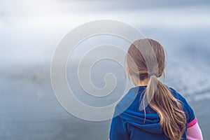 Female girl standing by a pond