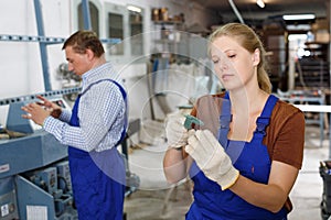 Female glazier measuring glass with caliper