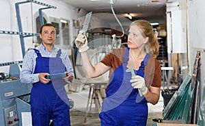 Female glazier working in glass factory