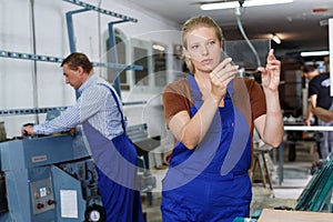 Female glazier working in glass factory