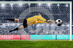 Female goalie is jumping for the ball on crowded stadium