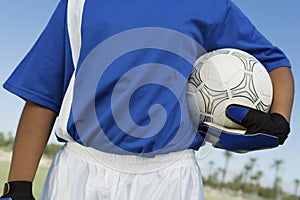 Female Goalkeeper Holding Soccer Ball