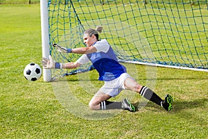 Female goalkeeper saving a goal