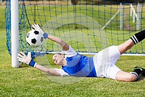 Female goalkeeper saving a goal