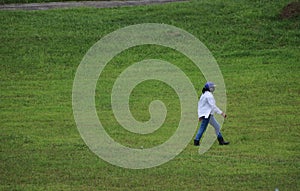 Female golf ball collector in the Philippines photo