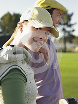 Female Golfer With Friends On Golf Course