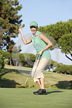 Female Golfer On Golf Course