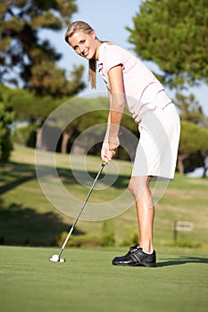 Female Golfer On Golf Course