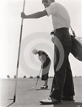 Female golfer and her caddy photo