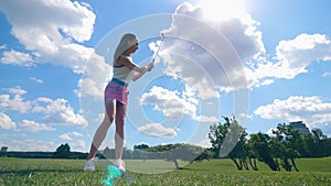 Female golfer hits a ball, standing on a field. Golfer plays golf, sport lifestyle concept.