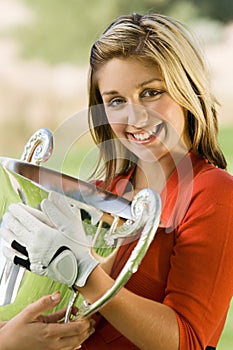 Female Golfer Holding Winning Trophy