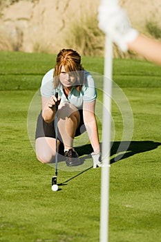 Female Golfer Lining Her Putt