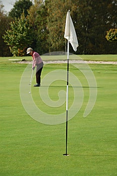 Female golfer putting