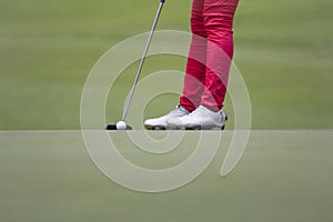 Female golfer putting