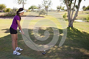 Female golfer ready to swing